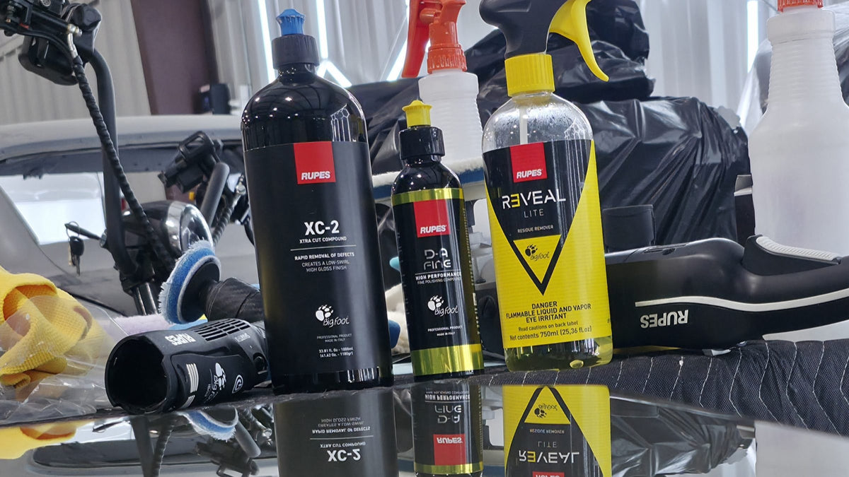 Rupes paint correction compounds and polisher on a hex-lit detailing table